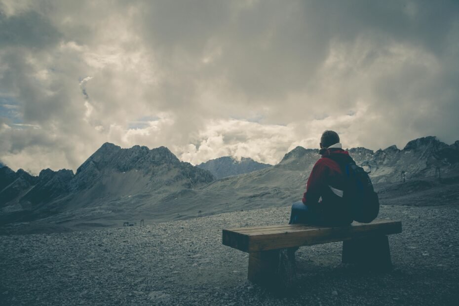 Solo traveler enjoying a vast landscape, symbolizing the freedom and self-discovery of independent travel in one of the best places to travel alone.