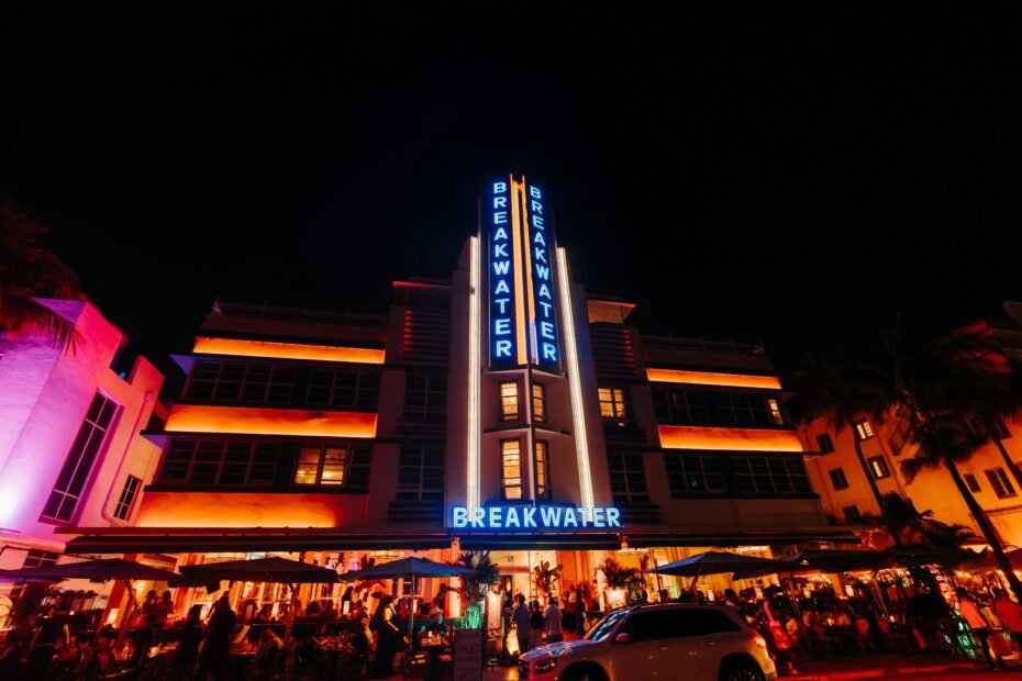 A lively view of the Wildwood nightlife on the Jersey Shore boardwalk, with colorful neon signs from bars and attractions lighting up the evening.