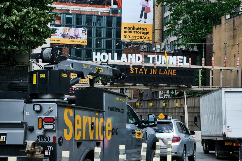 A large green highway sign showing the distance in miles to Newark and other New Jersey cities, illustrating the travel and distance theme of the article.