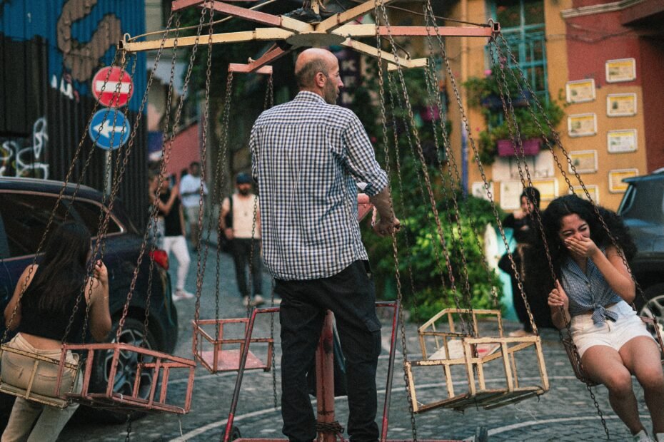 A young traveler with a backpack smiles while looking at a map on a picturesque cobblestone street, an example of an engaging budget travel activity.