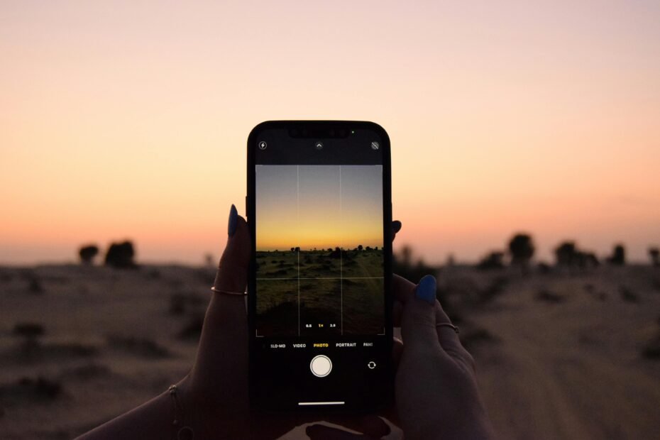 A smartphone showcasing the Monopoly GO Desert Tour event, with a colorful game board featuring desert landmarks and event rewards.