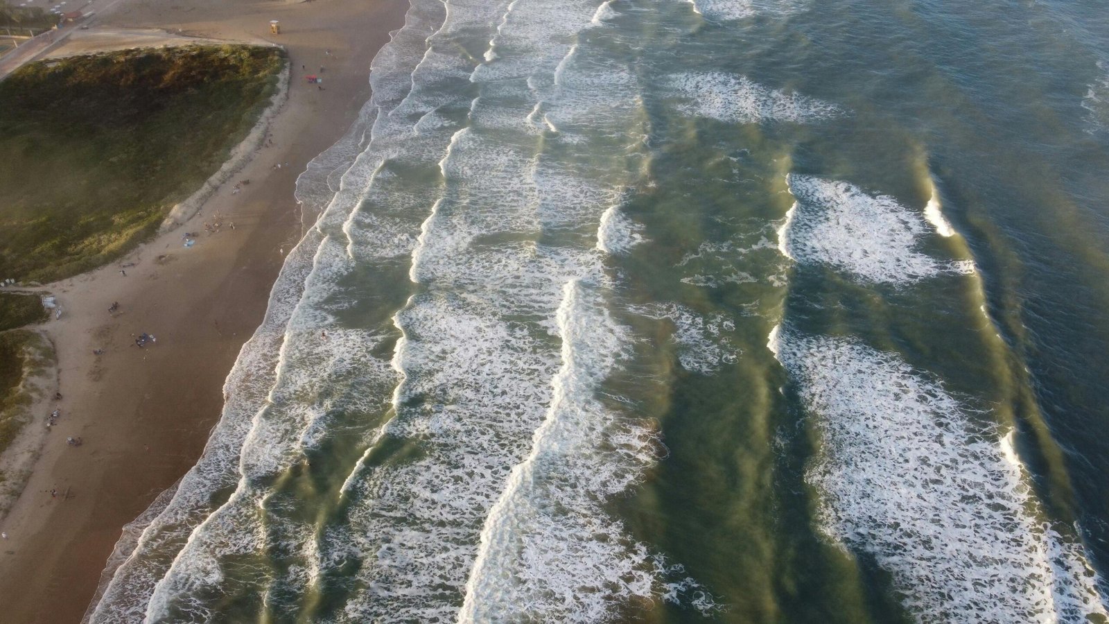 Pristine sandy beach on Padre Island, Texas, with calm, sparkling turquoise waters and a clear sky, embodying a perfect coastal escape.