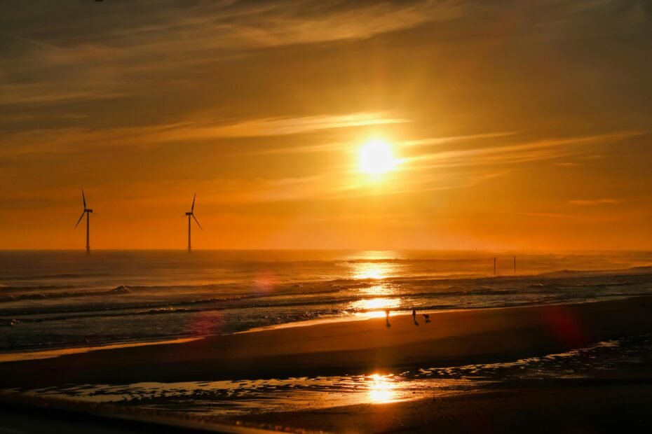 The wide, sandy beach of Wildwood Crest at sunrise, with gentle waves on the shore, illustrating a perfect beach getaway for a 2025 vacation in Wildwood Crest Cape May.