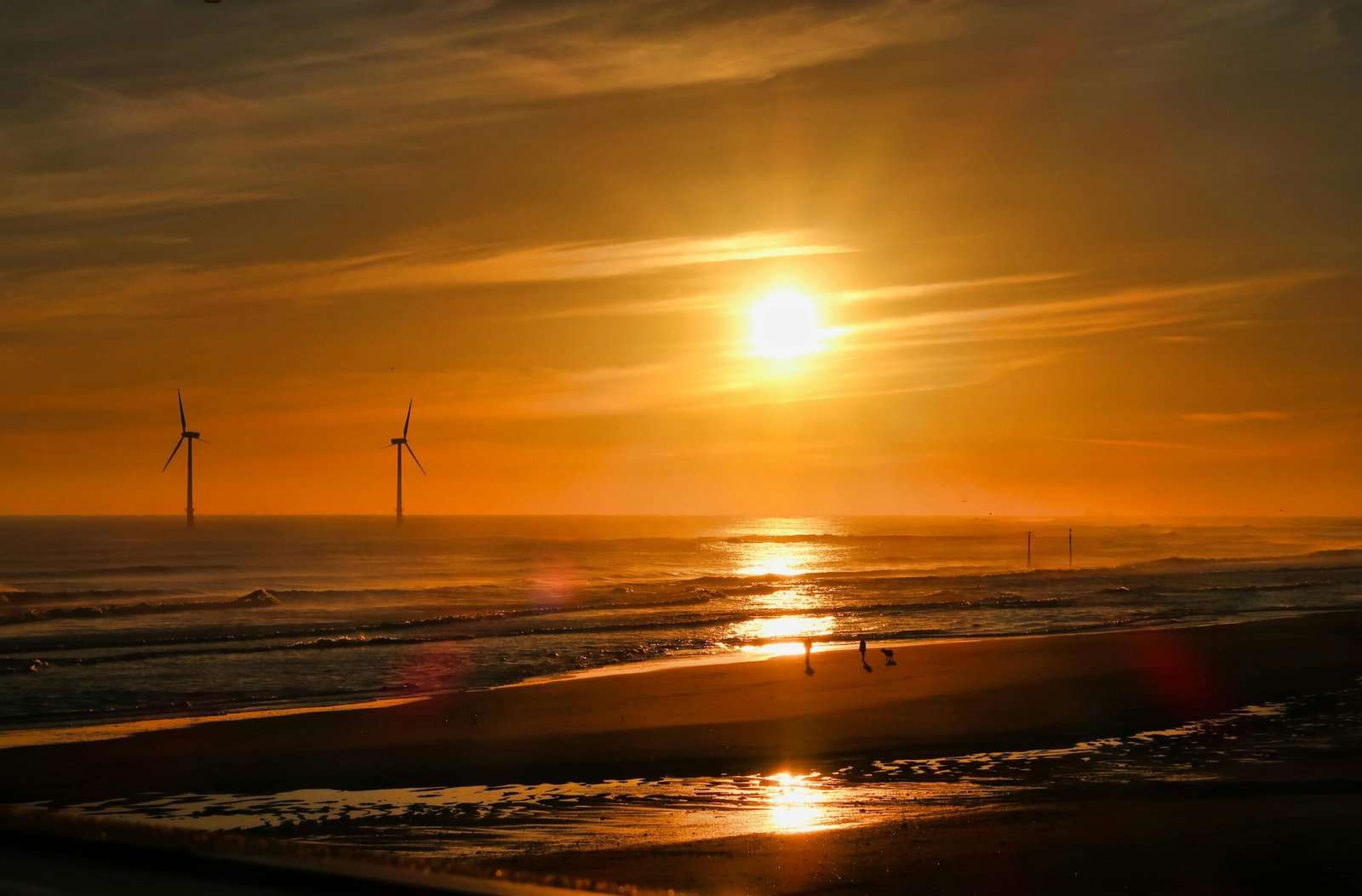The wide, sandy beach of Wildwood Crest at sunrise, with gentle waves on the shore, illustrating a perfect beach getaway for a 2025 vacation in Wildwood Crest Cape May.