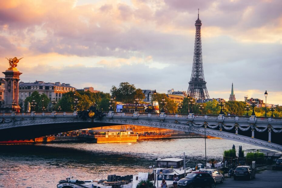 A panoramic view of one of the most beautiful cities in the world, with historic architecture and bridges over a river illuminated by the warm light of a sunset, illustrating the concept of urban beauty.
