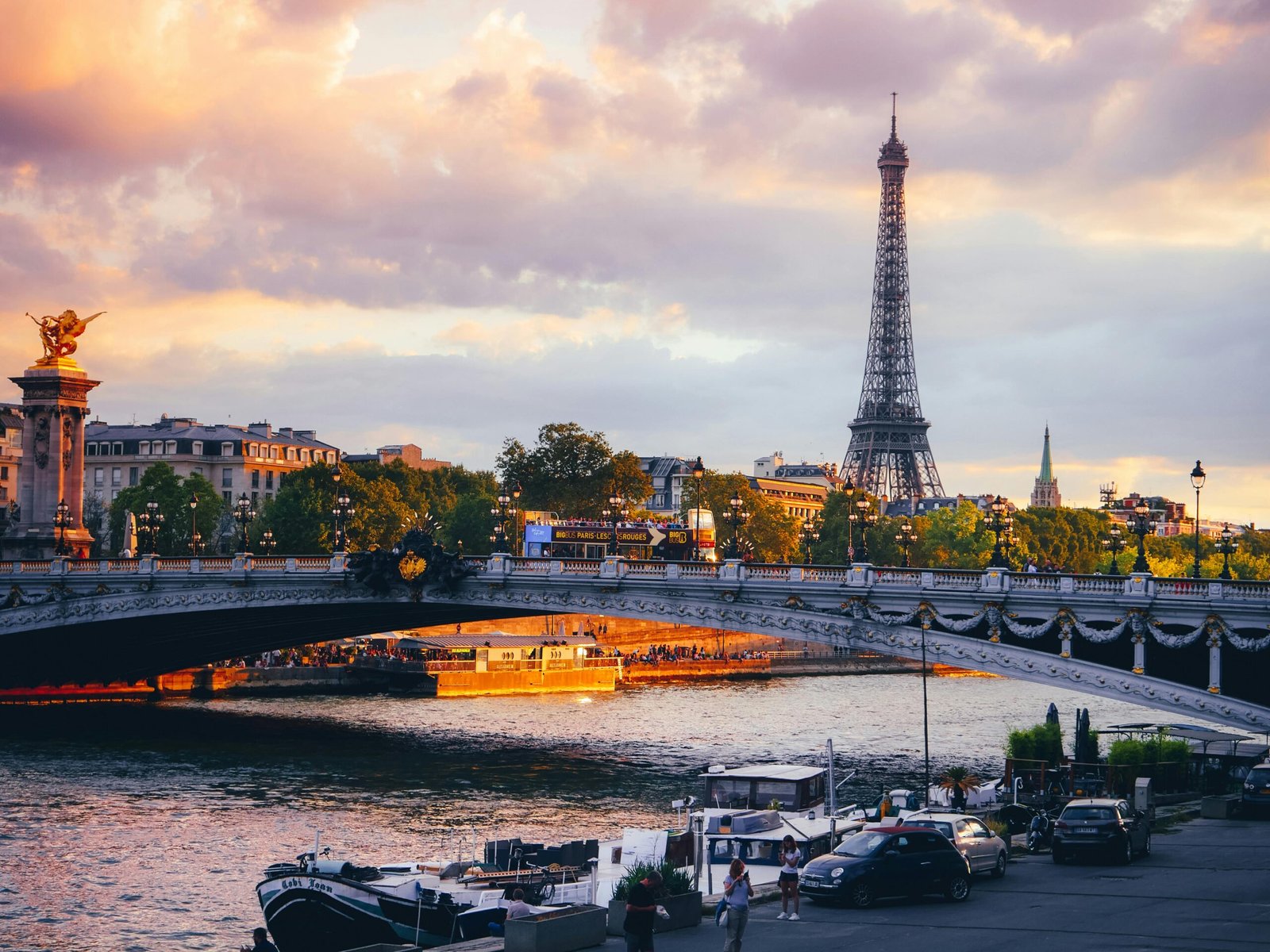 A panoramic view of one of the most beautiful cities in the world, with historic architecture and bridges over a river illuminated by the warm light of a sunset, illustrating the concept of urban beauty.