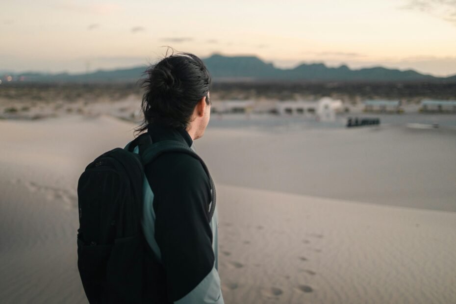 Desert tour rewards: serene landscape with a lone figure at sunset, symbolizing peace, personal growth, and adventure.