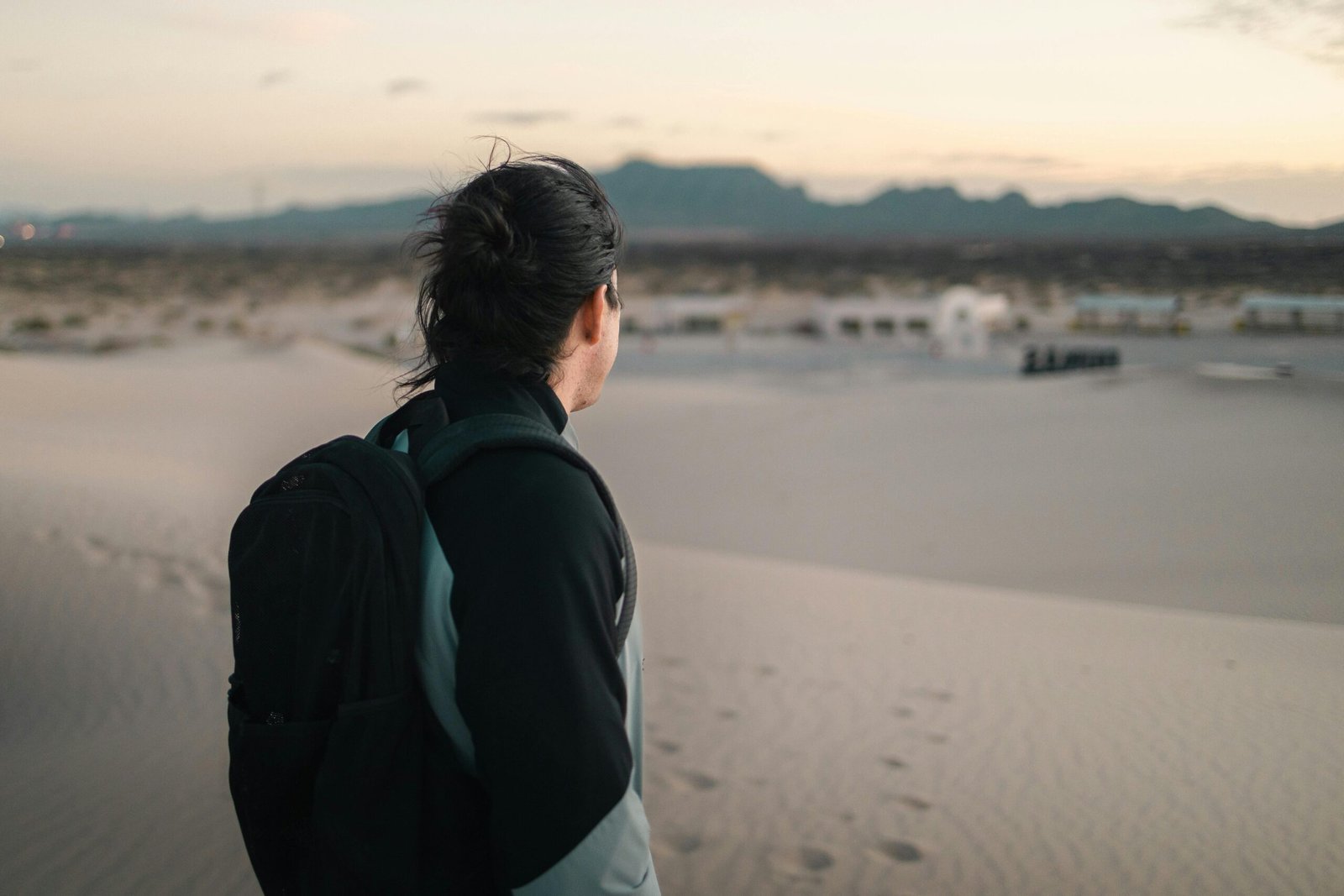 Desert tour rewards: serene landscape with a lone figure at sunset, symbolizing peace, personal growth, and adventure.