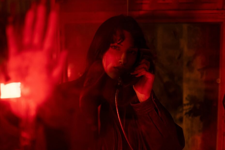 Retro-futuristic phone booth in a sci-fi cityscape, illustrating Stellar Blade's efficient in-game fast travel system and encouraging exploration for PlayStation 5 players.