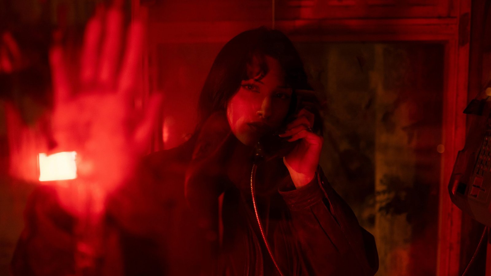 Retro-futuristic phone booth in a sci-fi cityscape, illustrating Stellar Blade's efficient in-game fast travel system and encouraging exploration for PlayStation 5 players.