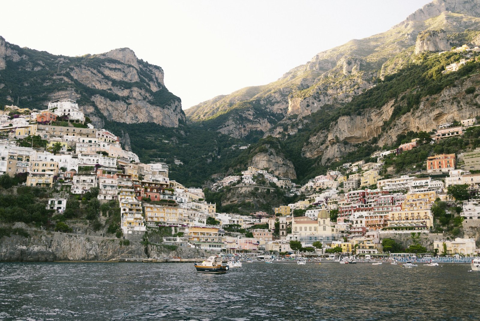 A traveler looking out at a scenic view of a colorful European coastal town, one of the best places to see in Europe for a memorable vacation.