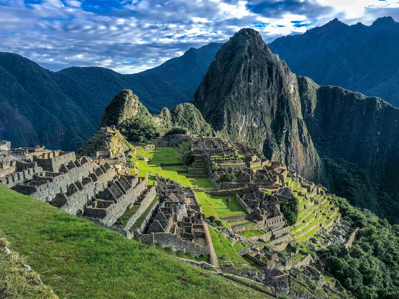 Panoramic view of South America's diverse landscapes, featuring iconic destinations like Machu Picchu, Patagonian mountains, and vibrant city life, embodying adventure travel inspiration.