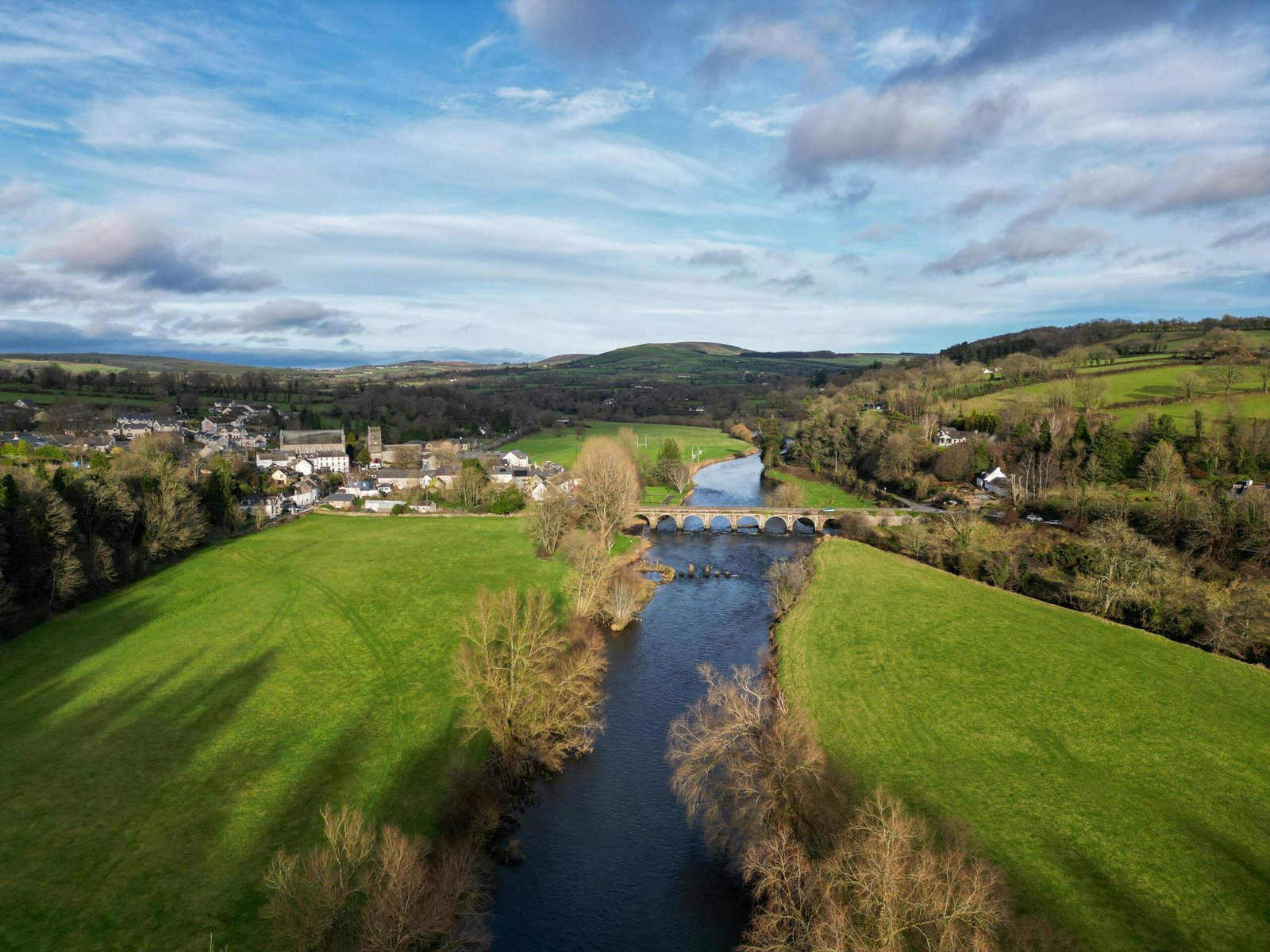 Scenic green landscape of Ireland with a winding road leading to the horizon, symbolizing an exciting first-time travel adventure and essential tips for visiting the Emerald Isle.