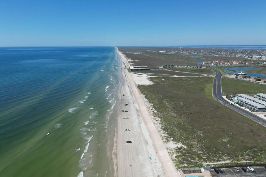 Stunning sandy beach on the Texas Gulf Coast, featuring clear waters and a wide, inviting shoreline, perfect for a surprising beach vacation in Texas.