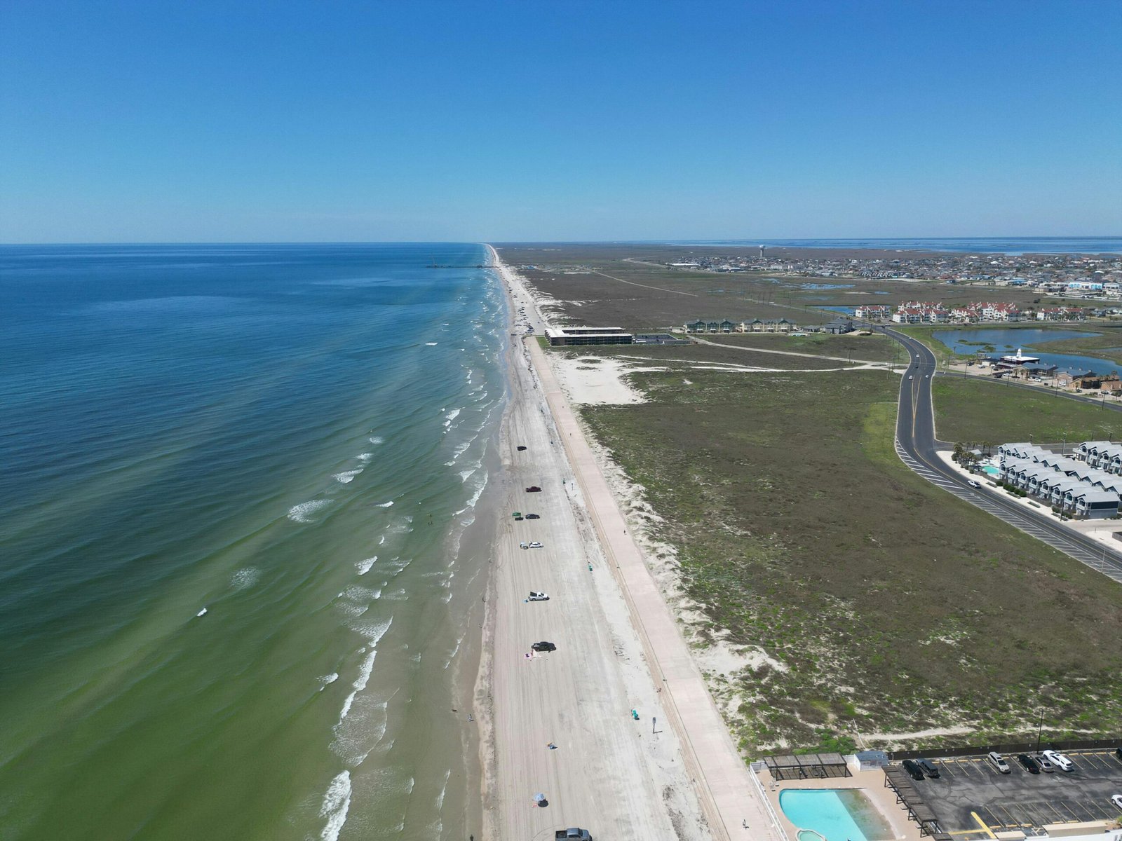 Stunning sandy beach on the Texas Gulf Coast, featuring clear waters and a wide, inviting shoreline, perfect for a surprising beach vacation in Texas.