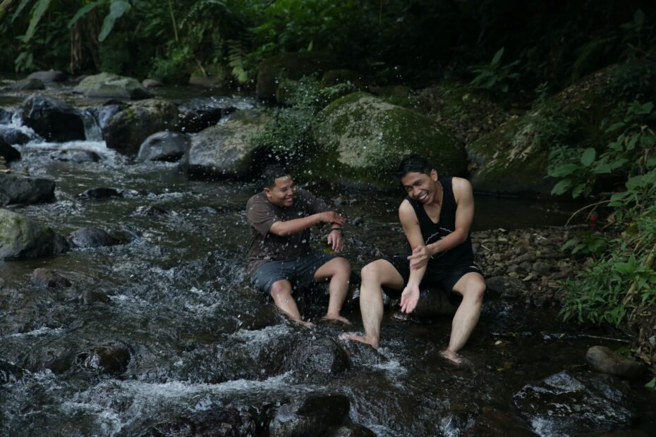 SModcast Scott Mosier travel stories: Two podcast hosts laughing over a funny anecdote, capturing the authentic humor of filmmaking adventures, film festivals, and relatable personal mishaps shared on the show.