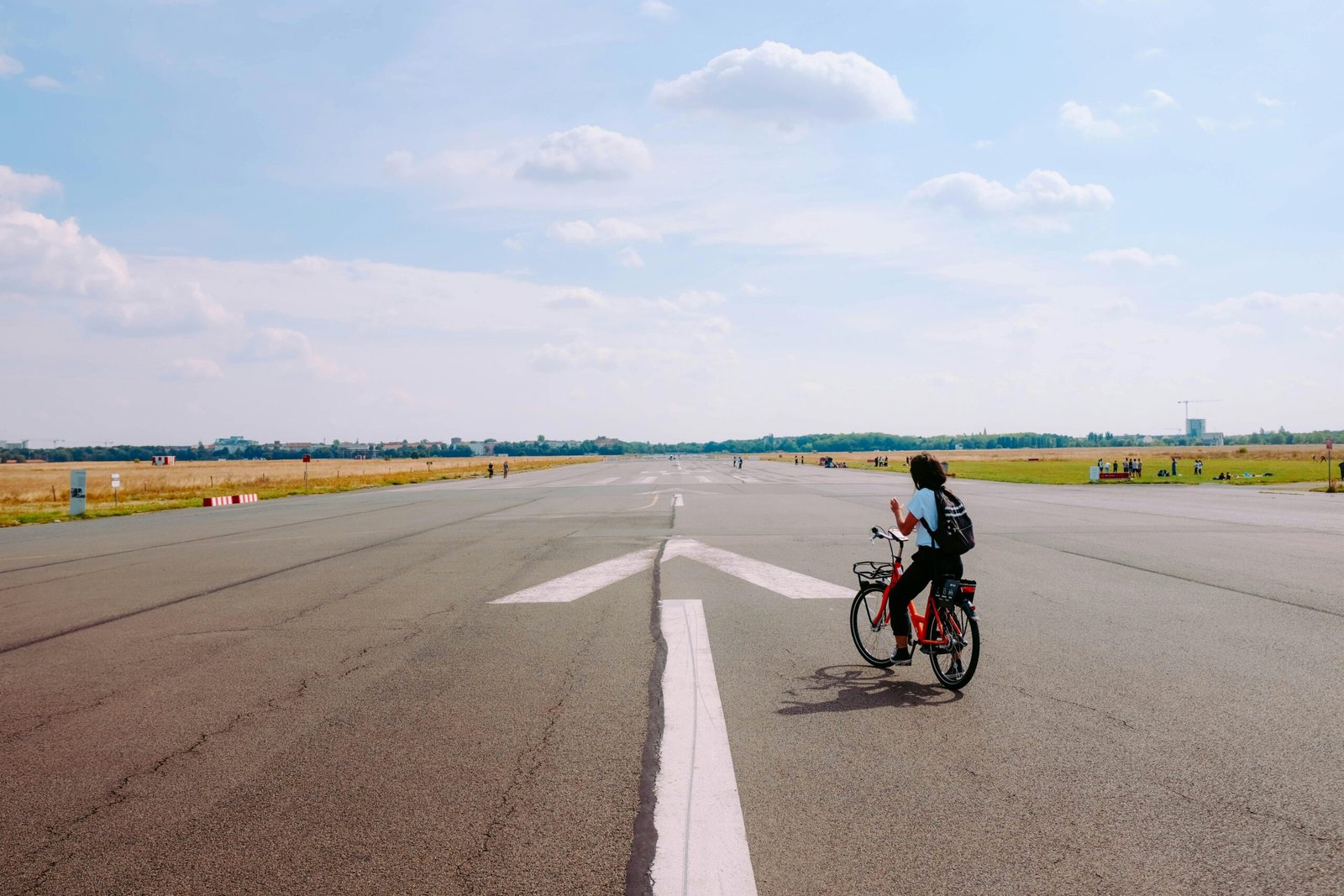 A cyclist effortlessly navigating an airport with a durable wheeled bike travel case, symbolizing secure and stress-free bicycle travel for their next cycling adventure.