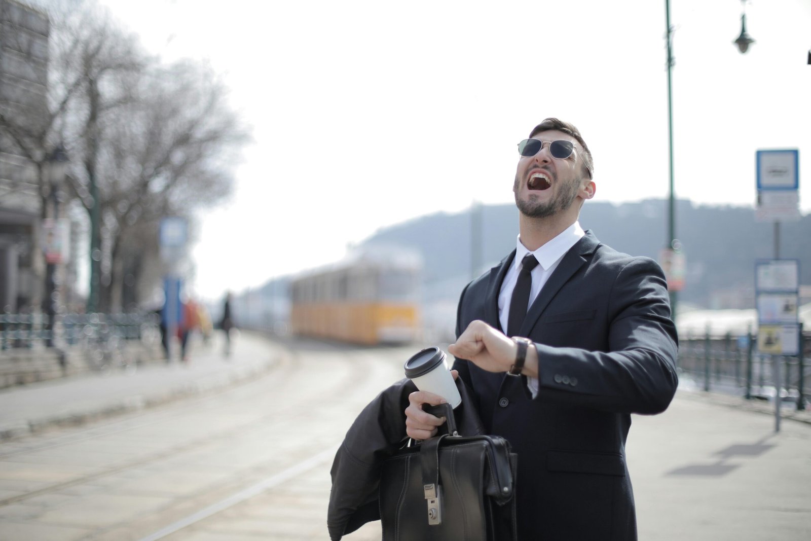 A happy traveler sitting in an airport lounge, laughing while looking at their phone and finding inspiration for a funny travel meme.