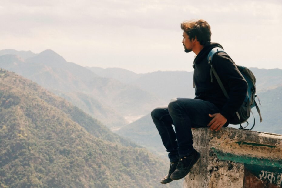 A traveler looks out over a beautiful scenic landscape, contemplating the best places to travel in April from Australia.