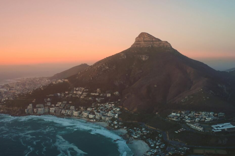 A breathtaking panoramic view of one of the most stunning cities in the world, where the city skyline meets a majestic mountain range and the sea, inspiring future travel adventures.