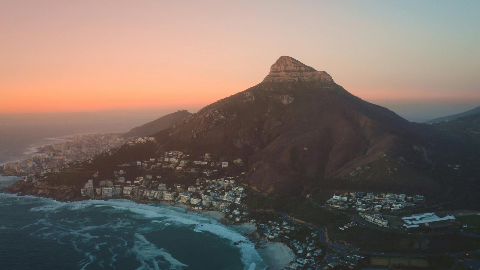 A breathtaking panoramic view of one of the most stunning cities in the world, where the city skyline meets a majestic mountain range and the sea, inspiring future travel adventures.