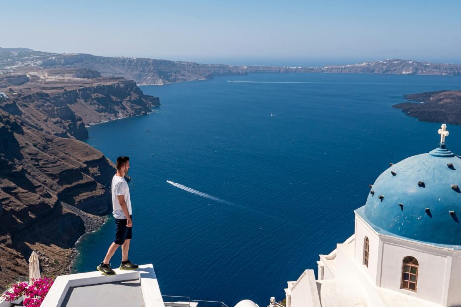 A traveler overlooking a beautiful scenic landscape, representing one of the best places to travel in the summer for a perfect vacation.