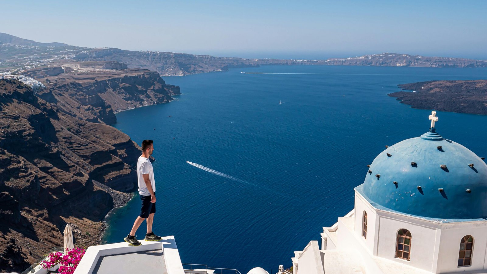 A traveler overlooking a beautiful scenic landscape, representing one of the best places to travel in the summer for a perfect vacation.