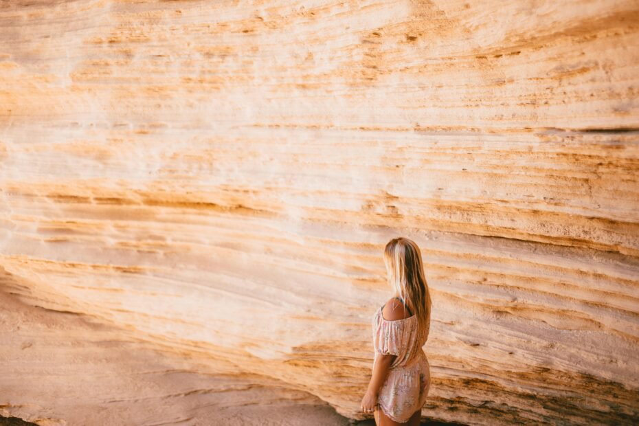 A confident solo traveler looking out over a scenic landscape, illustrating the freedom and empowerment of a solo travel adventure.