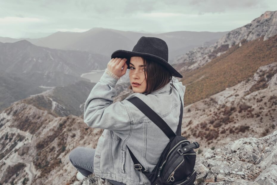 Empowered solo female traveler exploring a beautiful natural landscape, illustrating safe and inspiring travel destinations for women.