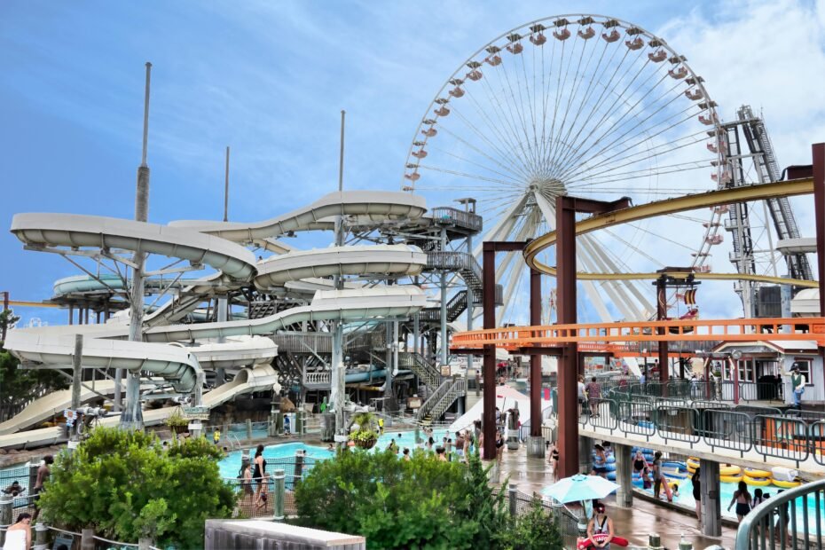 A sunny view of the wide Wildwood beach and iconic boardwalk, showcasing the perfect location for Wildwood rentals for a 2025 Jersey Shore vacation.