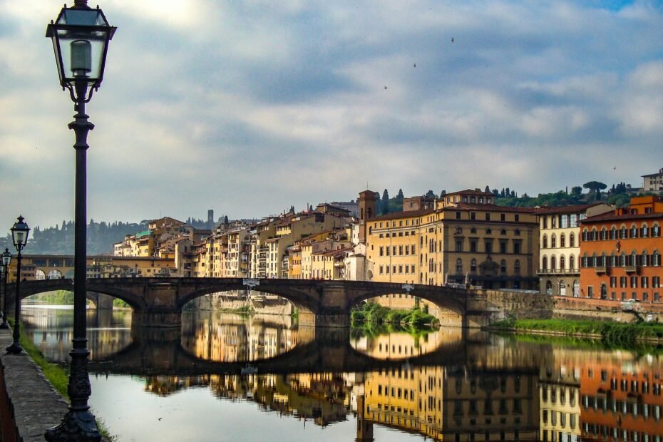 Breathtaking panoramic view of a beautiful city at sunset, showcasing a perfect blend of historic architecture and a serene river, illustrating a dream travel destination.
