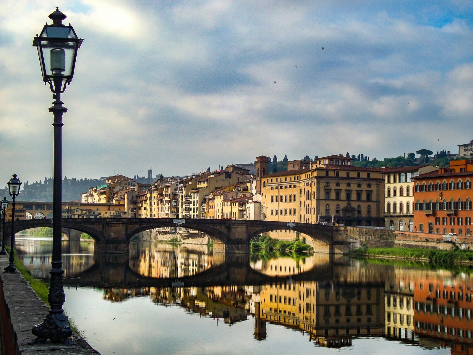 Breathtaking panoramic view of a beautiful city at sunset, showcasing a perfect blend of historic architecture and a serene river, illustrating a dream travel destination.