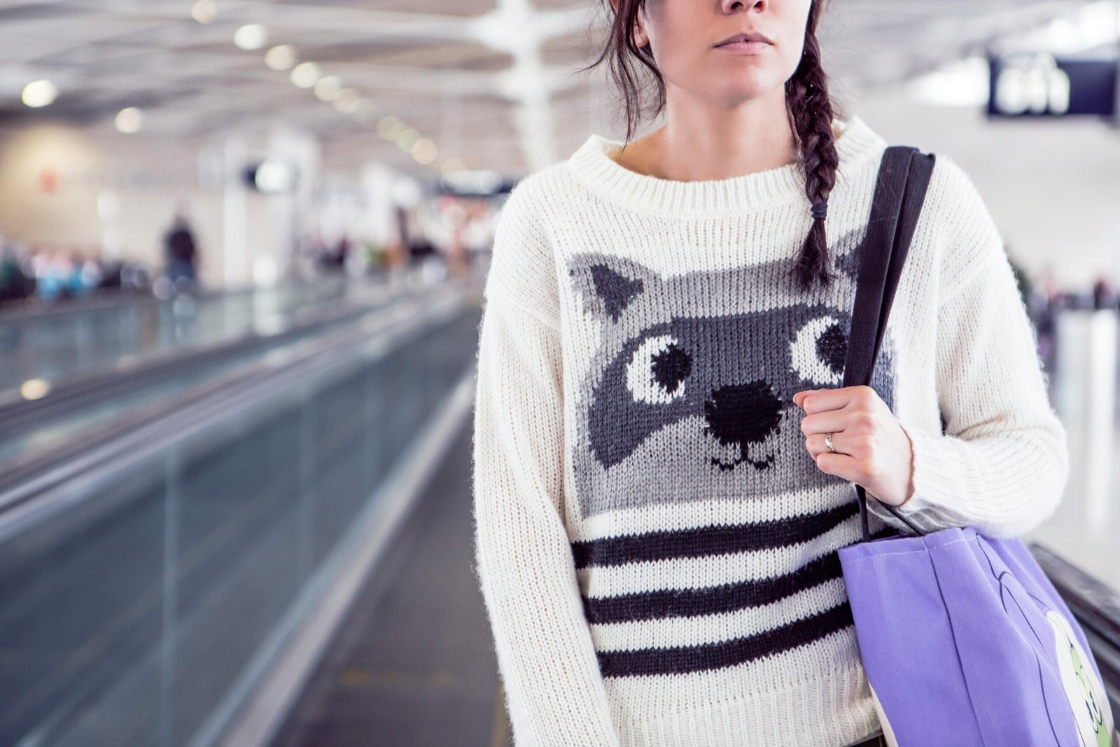 Traveler confidently pulling a wheeled ski bag through an airport terminal, highlighting secure ski gear protection and convenient travel for a winter ski trip.