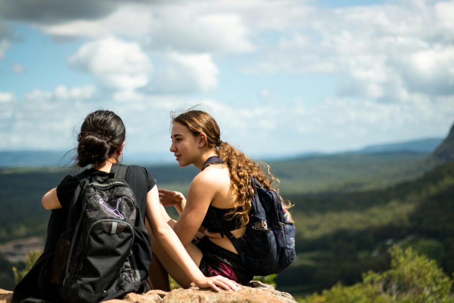 The Wellness Twins, Anna and Chloe, actively enjoying a healthy travel lifestyle in a scenic destination, showcasing practical fitness and wellness tips for travelers.