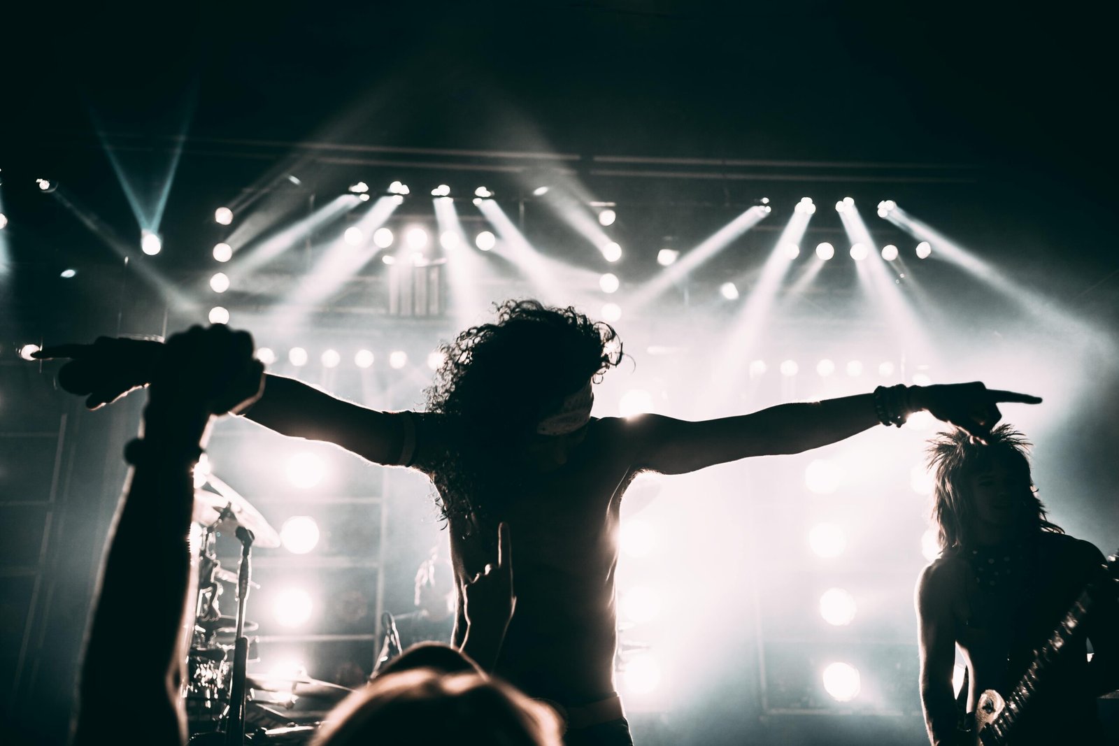 Energetic live Blues Traveler concert with John Popper playing harmonica on stage, vibrant lighting, and an enthusiastic crowd enjoying the blues rock jam session.
