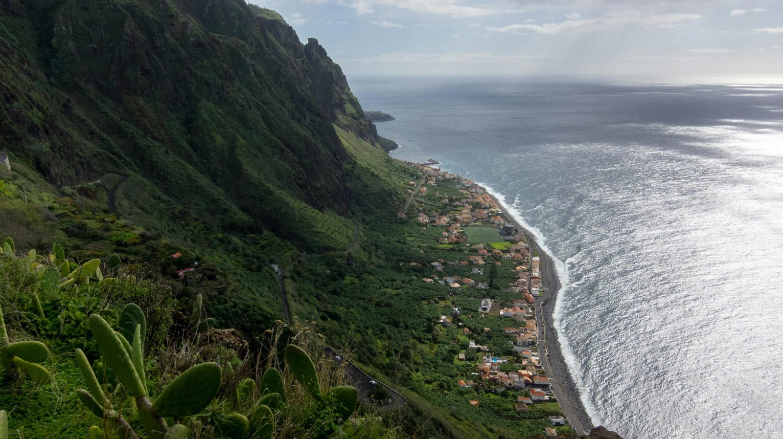 Lush green panoramic view of Madeira Island, Portugal, showcasing its year-round mild climate and stunning natural beauty for an ideal travel experience.
