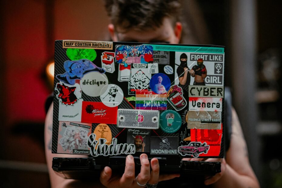 A close-up of a personalized suitcase, laptop, and water bottle adorned with a vibrant collection of unique travel stickers, symbolizing adventures, cherished memories, and individual wanderlust.