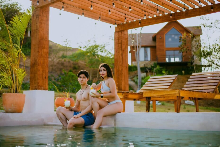 Couple relaxing at a stunning all-inclusive luxury resort on a tropical beach, highlighting the stress-free value of a Costco Travel vacation package.