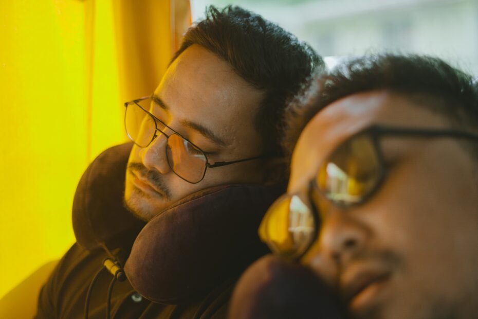 Happy traveler sleeping soundly with a supportive U-shaped neck travel pillow during a long flight, showcasing comfortable and pain-free journeys.