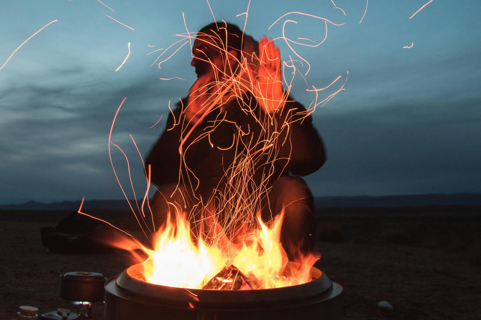 Close-up of a pyro traveller ferrocerium rod creating intense sparks to start a fire in a wilderness setting, symbolizing reliable outdoor survival gear and essential fire starting.