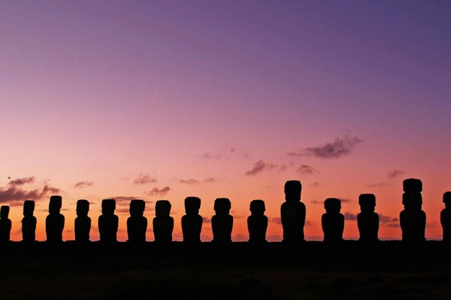Iconic moai stone statues standing on the remote, ancient landscape of Easter Island (Rapa Nui), inviting travelers to explore its unique history.