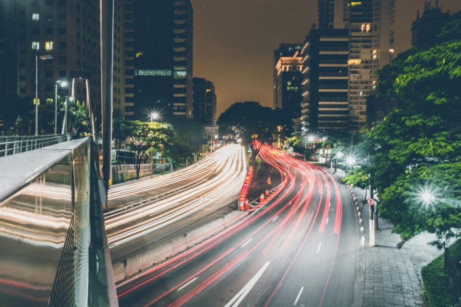 Modern highway travel center exterior at night with bright lights, showing trucks and cars, symbolizing a welcoming rest stop with fuel, food, and amenities for travelers.