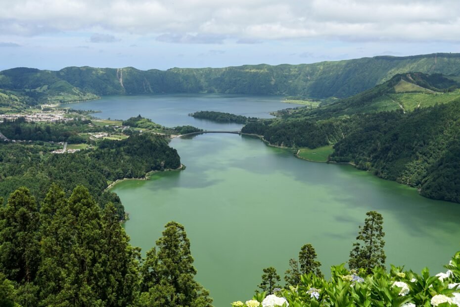 Panoramic view of lush green volcanic landscape with serene twin lakes in the Azores, ideal for exploring azores travel packages.