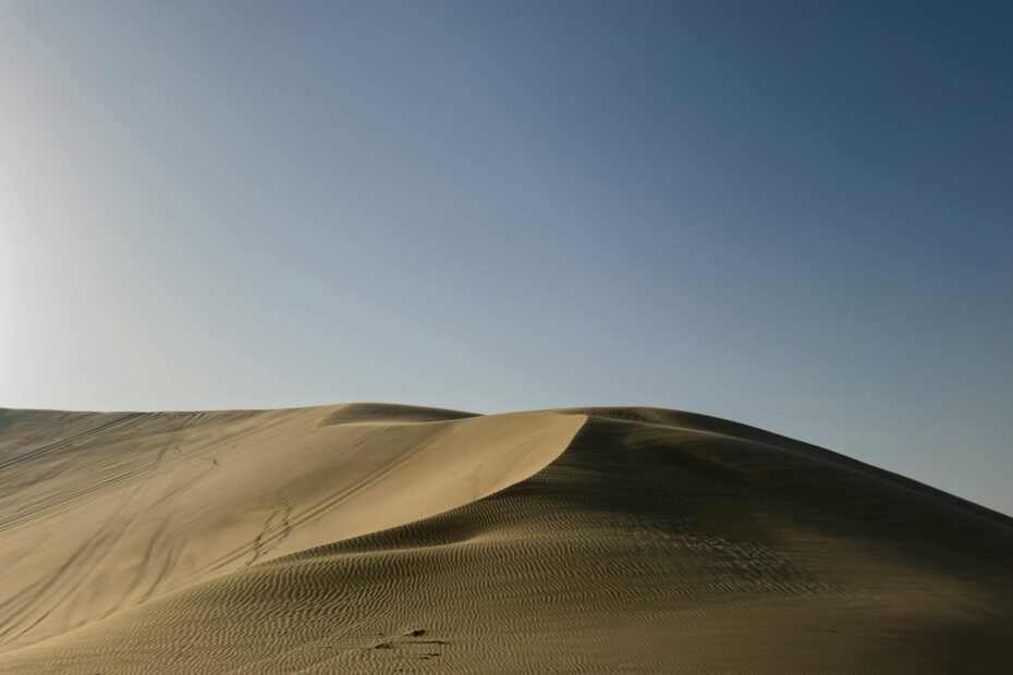 Machu Picchu, Peru, under a clear blue sky during the dry season, symbolizing the ideal time for trekking and exploring the ancient Inca ruins in the Andes.
