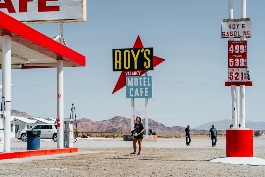 Classic Route 66 travel center with vintage gas pumps and retro signage, an essential stop for road trippers seeking fuel, food, and souvenirs along the historic Mother Road.