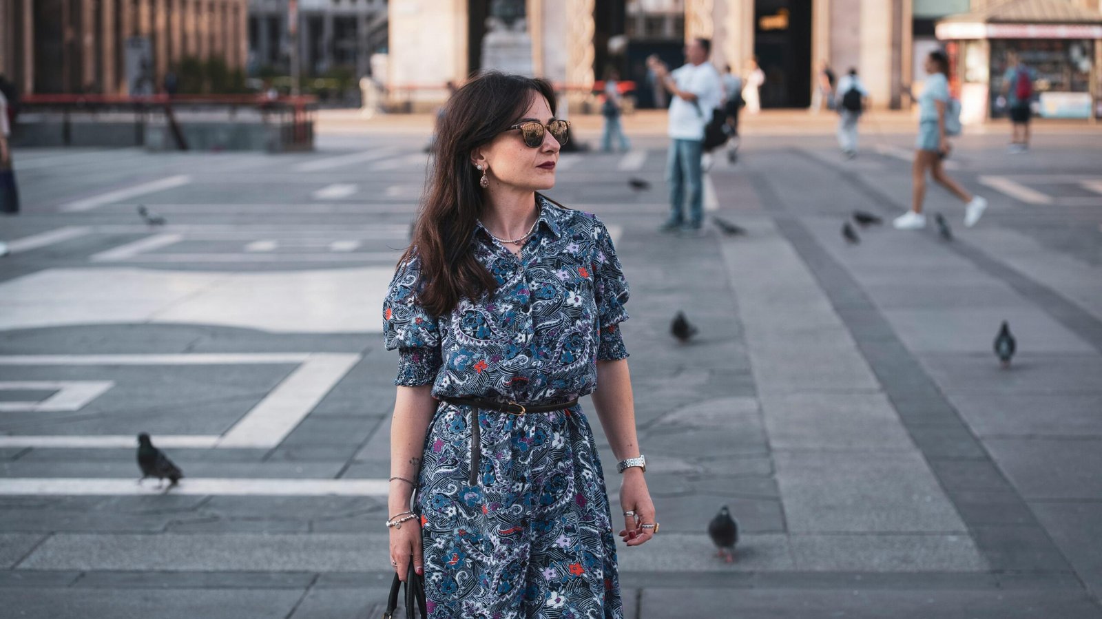 Stylish woman confidently exploring a city with a modern anti-theft crossbody travel purse, highlighting secure and functional travel bags for women.