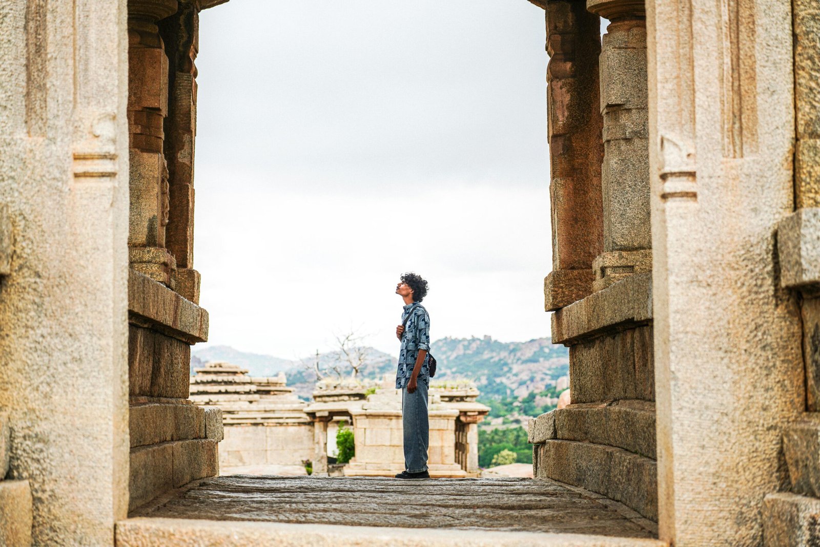 Traveler exploring majestic ancient ruins, symbolizing the enriching experience of historic site travel, cultural discovery, and connecting with the past.