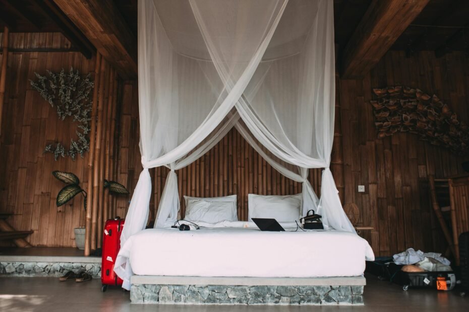 A pristine white traveling mosquito net gracefully draped over a bed in a tranquil tropical bedroom, providing essential insect protection and ensuring peaceful, disease-free sleep for travelers.