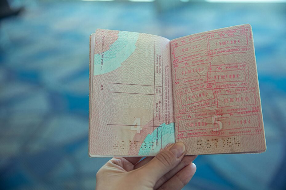 Close-up of a passport and official travel documents on a table, symbolizing US international entry requirements, visa policies, and travel eligibility.