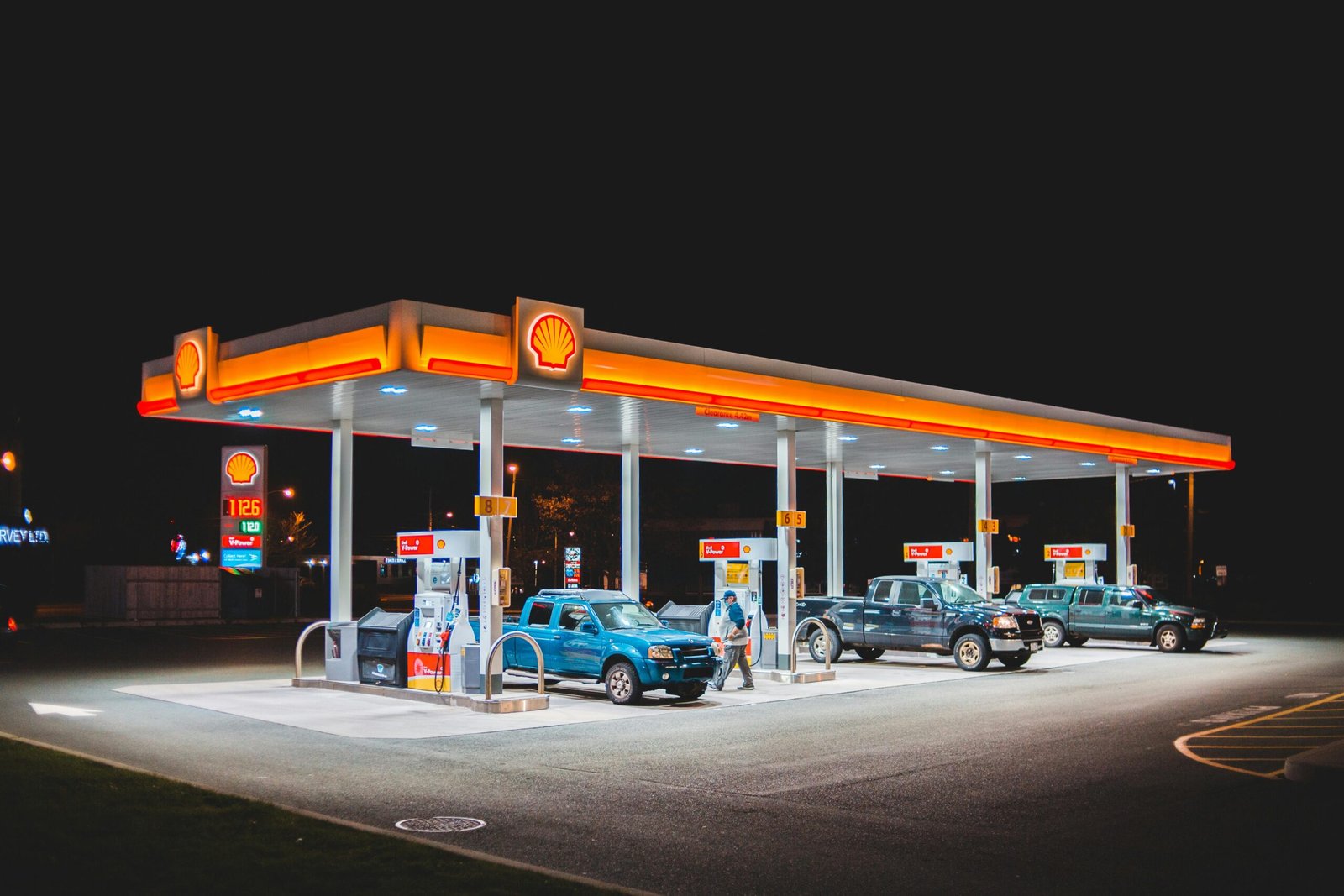 Modern Chickasaw Travel Stop (CTS) exterior at dusk, featuring a brightly lit gas station and convenience store entrance, symbolizing a safe and welcoming stop for Oklahoma road trip travelers seeking fuel, food, and essential services.